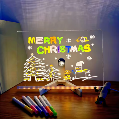 GlowSketch Board displaying illuminated Christmas scene with colorful markers, showing creative drawing capabilities on clear surface
