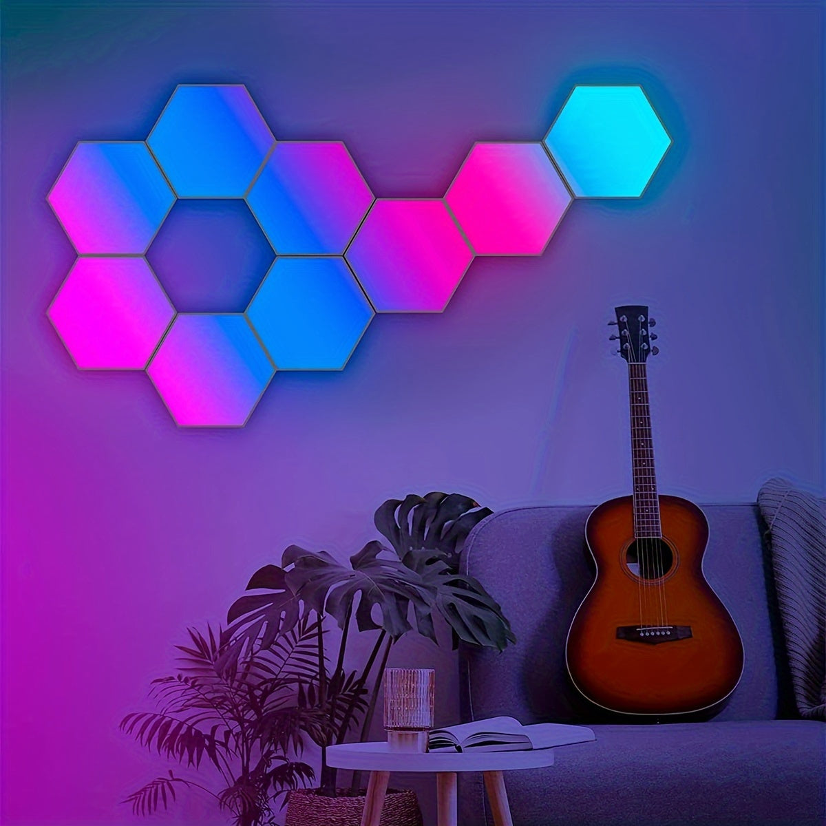 HexLights modular LED panels glowing in blue and pink tones above acoustic guitar and houseplant in modern living space