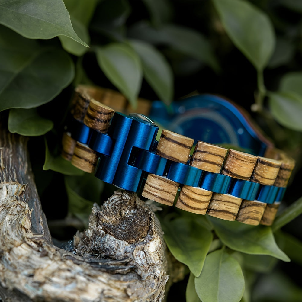 HighPeak BOBO BIRD engraved wooden watch with zebra wood and blue metal links displayed on natural wood against green foliage