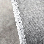 HighPeak Black Basketball Court Rug featuring close-up of white decorative braided edge trim on durable gray fabric backing