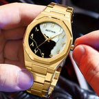 HighPeak Eclipse Royale gold-tone watch with split black and white Arabic dial, showcased on steel bracelet in hand