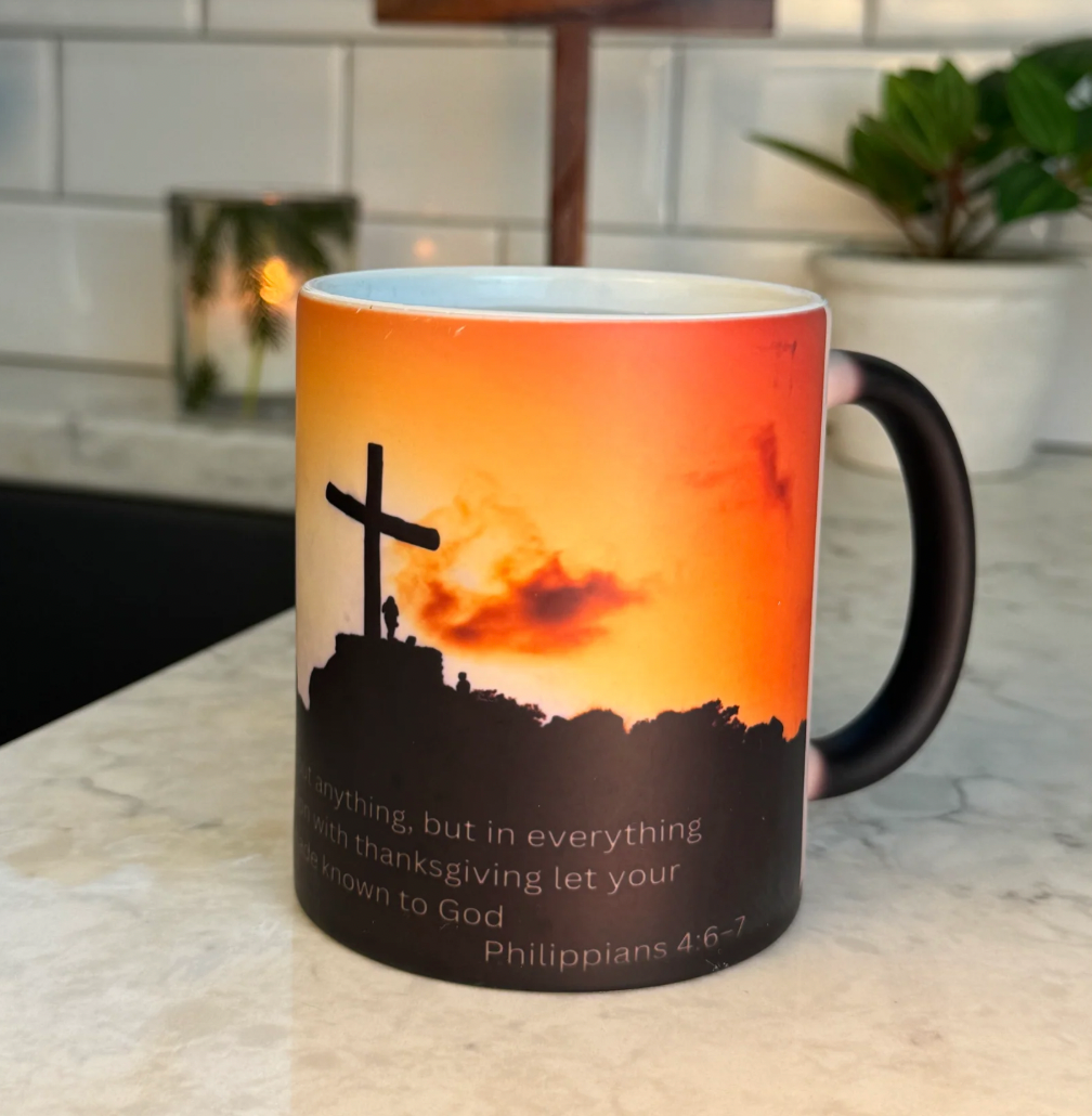 HighPeak FaithGlow Mug featuring cross silhouette against orange sunset with Philippians scripture verse on marble counter