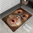 HighPeak Monkey See Monkey Rug featuring realistic 3D brown primate face design on plush floor mat with slippers beside