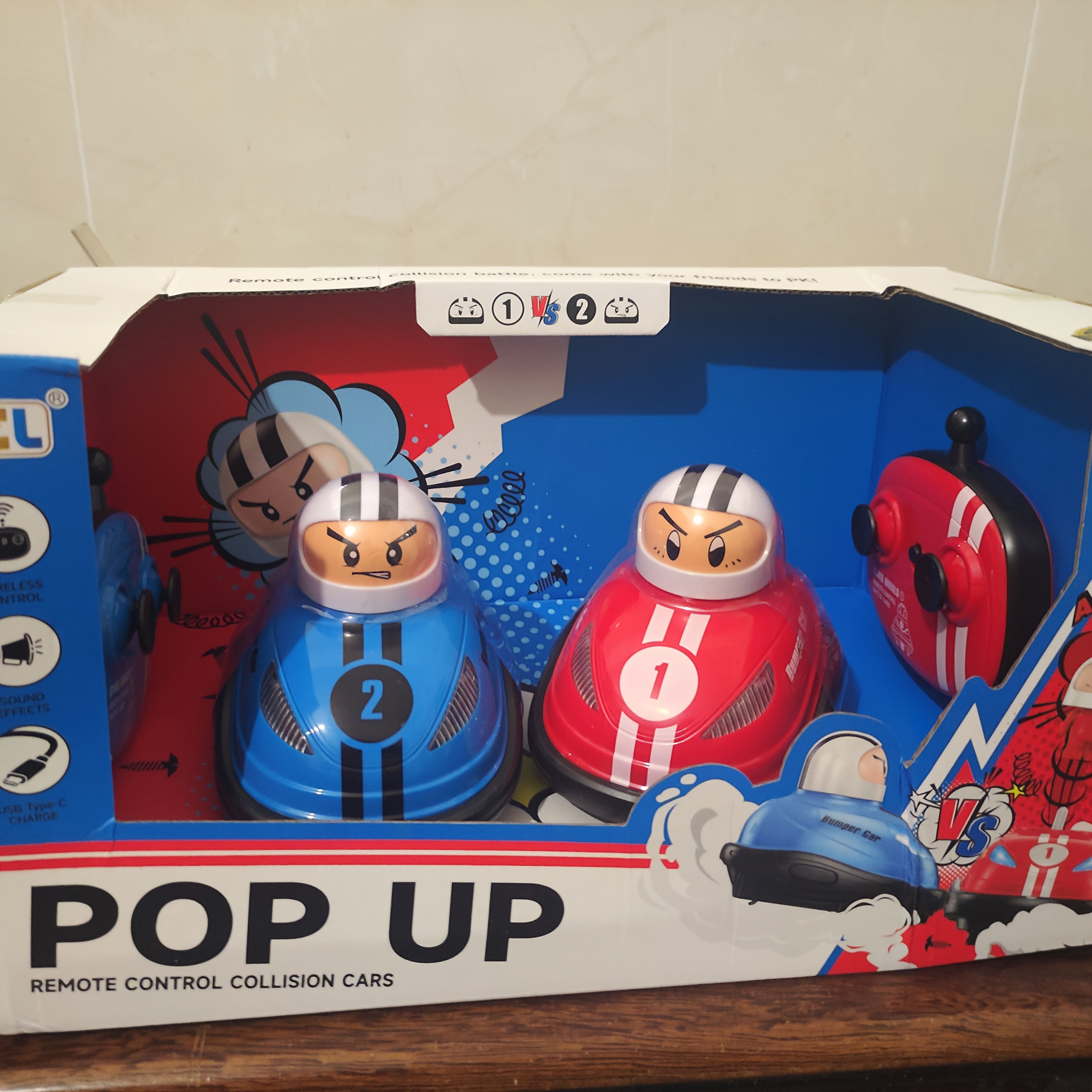 HighPeak Pop Up RC Bumper Cars set featuring red and blue collision cars with ejectable drivers in retail packaging