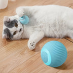 HighPeak PounceBall smart cat toy in turquoise shown with cat on wooden floor - interactive pet play ball