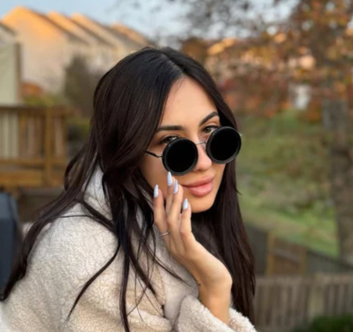 HighPeak ShiftLens round black sunglasses with adjustable lenses worn outdoors in autumn setting, paired with cream sweater