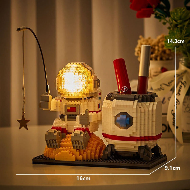 HighPeak Starlight Voyager brick astronaut with illuminated helmet and pen holder pod on lunar surface display - space themed desk decor