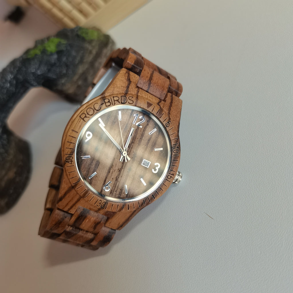 HighPeak TimberTime handcrafted zebra wood watch with brown face and silver hands displayed on dark textured surface