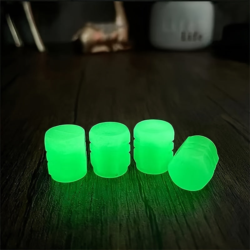 HighPeak TireValve glow-in-the-dark green valve caps lined up on dark wooden surface demonstrating luminescent effect