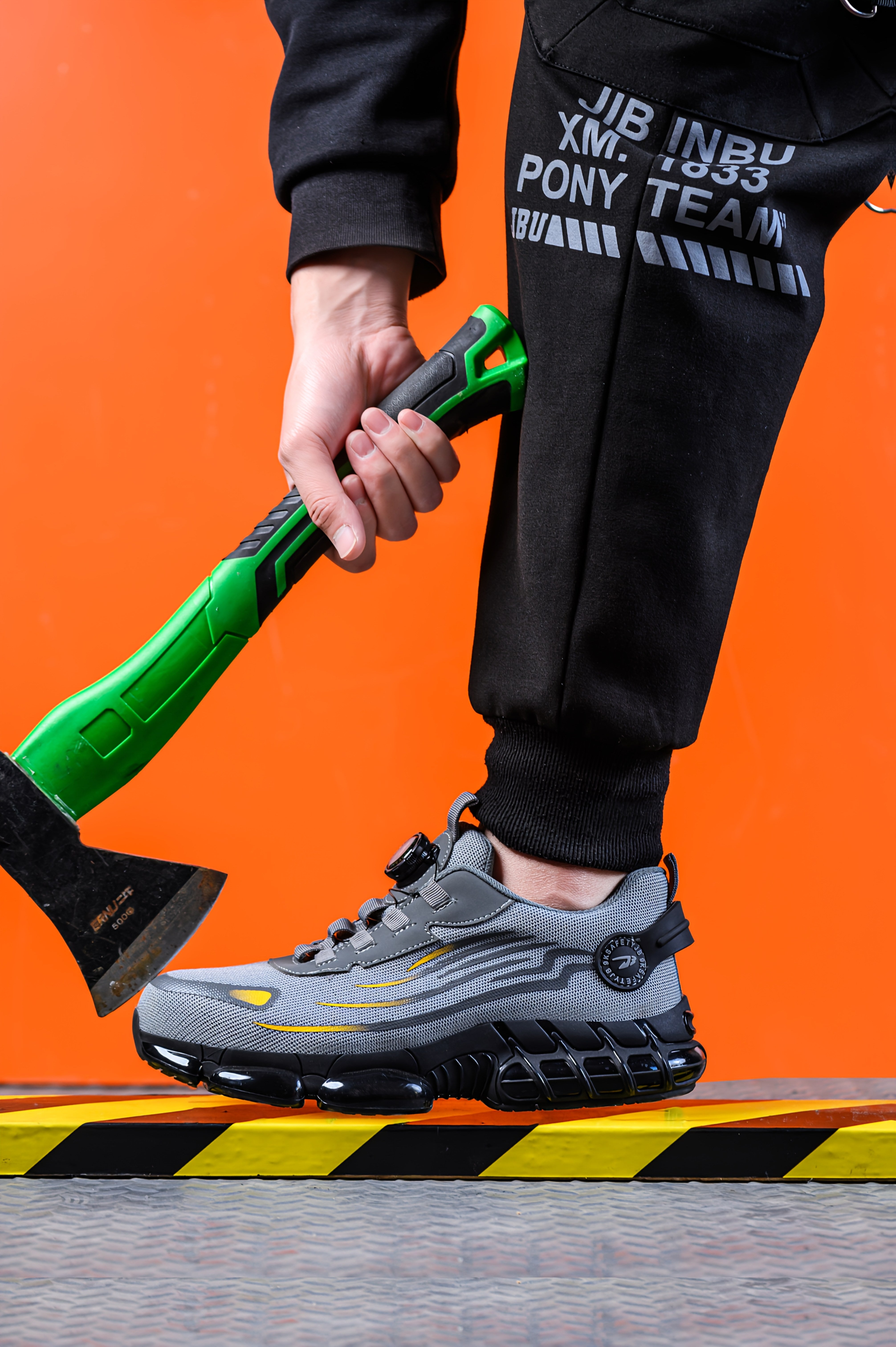 TitanStep safety shoes in gray with wave design and dial system shown with axe against orange background