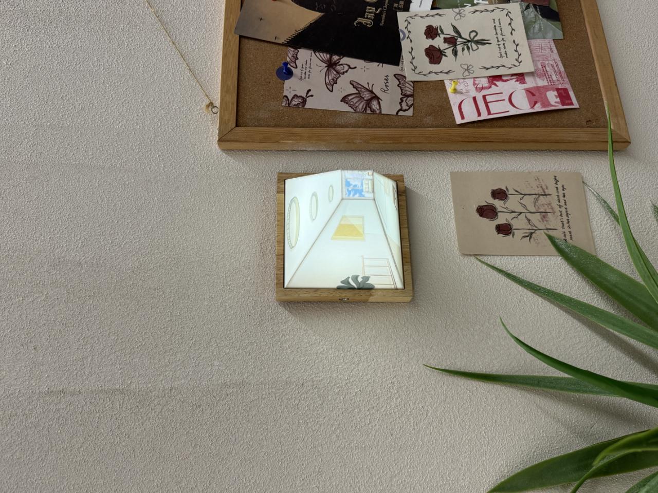 HighPeak Wallusion 3D illusion art frame mounted on cream wall with decorative plant and gallery wall display