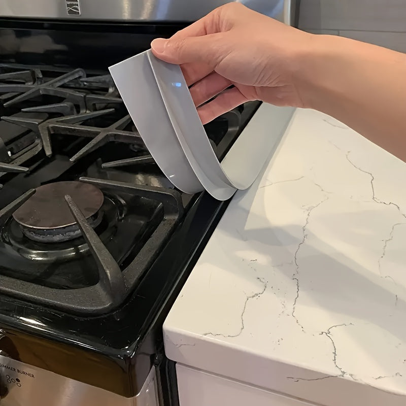 Kitchen Gap Guard silicone cover being placed between stove and counter - demonstrates easy installation and gap protection