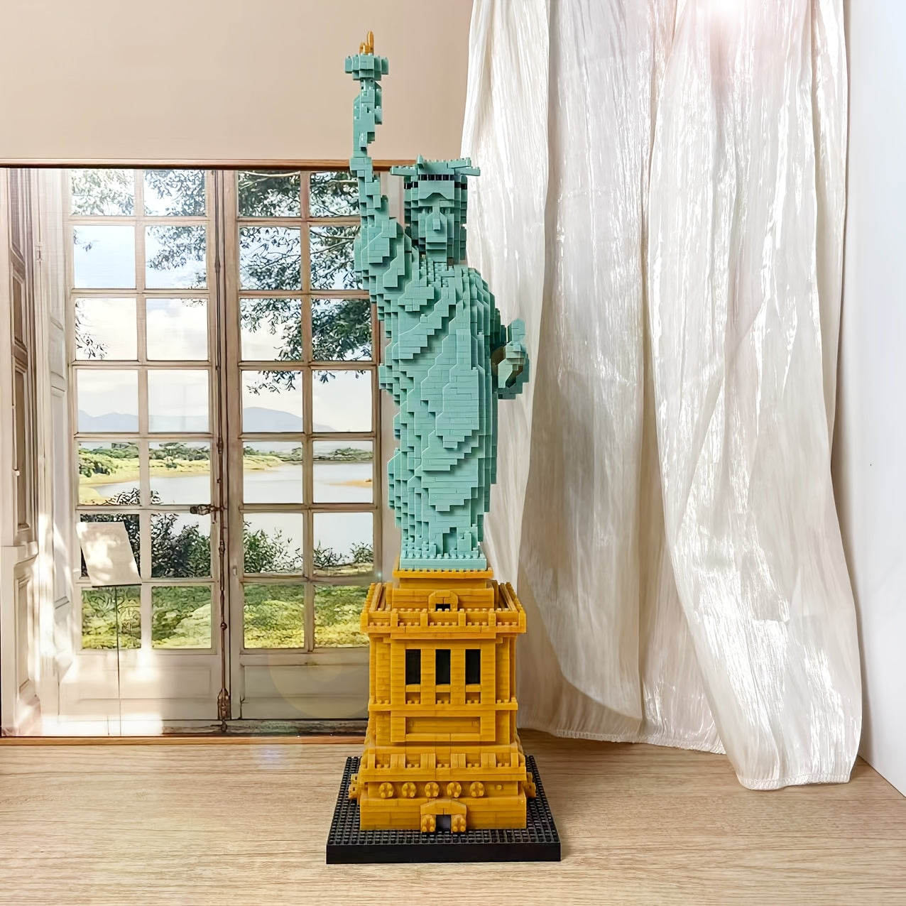 LibertyBrick Masterpiece 3D puzzle model in turquoise and gold displayed near window, sunlit detailed Statue of Liberty replica