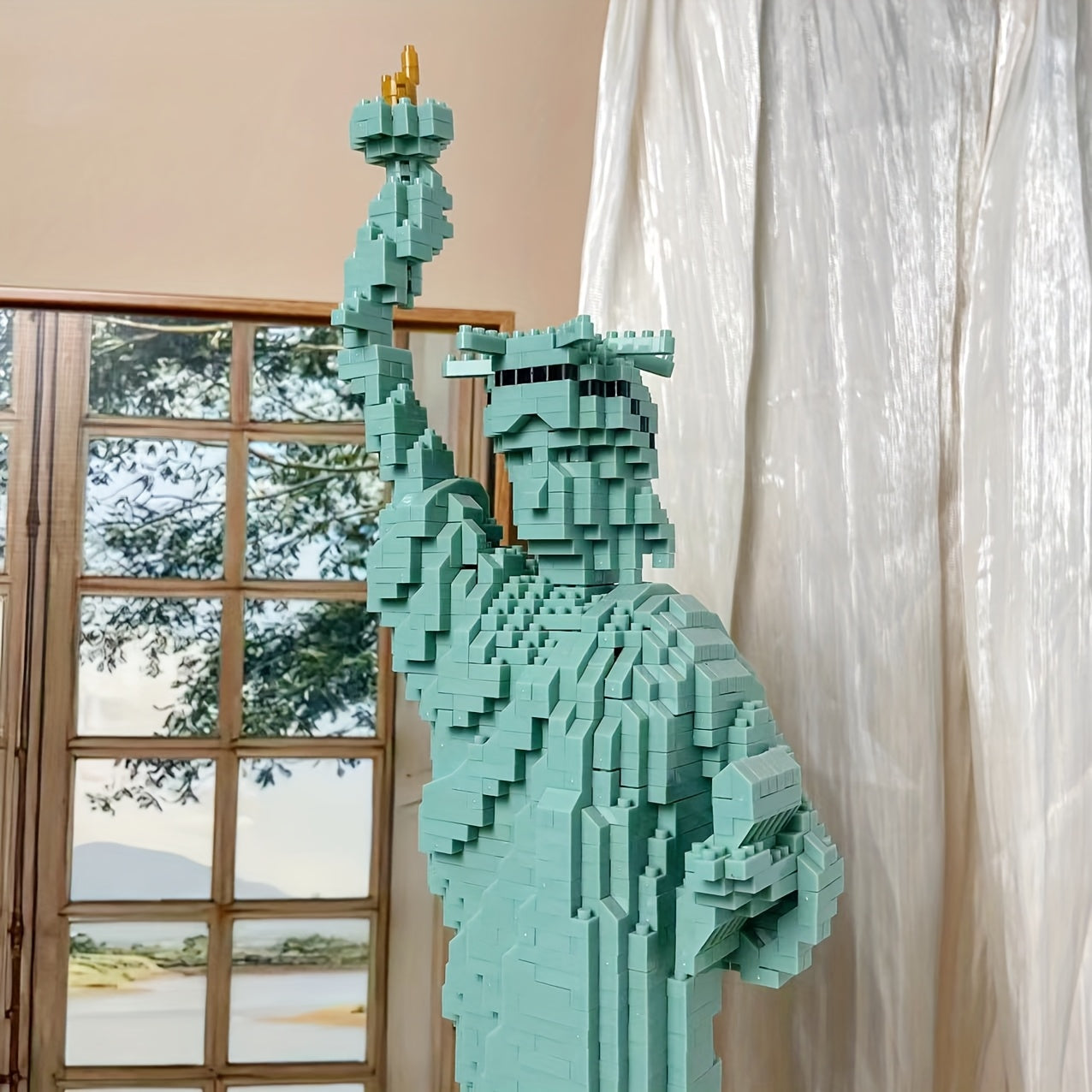 LibertyBrick Masterpiece turquoise 3D brick model of Statue of Liberty displayed near window with natural lighting