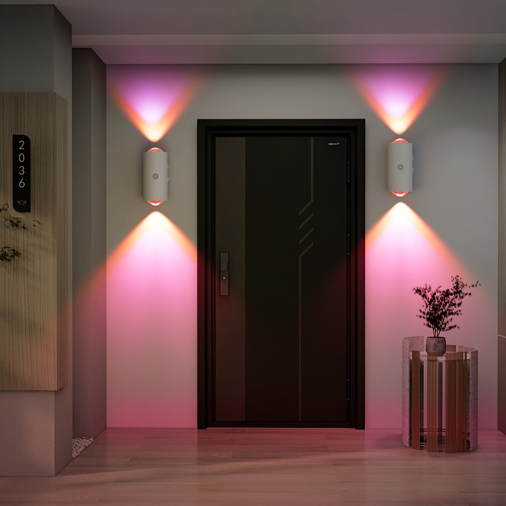 LumeGlow motion-sensing wall lights casting pink ambient glow around modern black door entrance with decorative plant