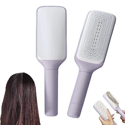 LuxeBrush self-cleaning hairbrush in white with paddle design and textured bristles, showing front and back views