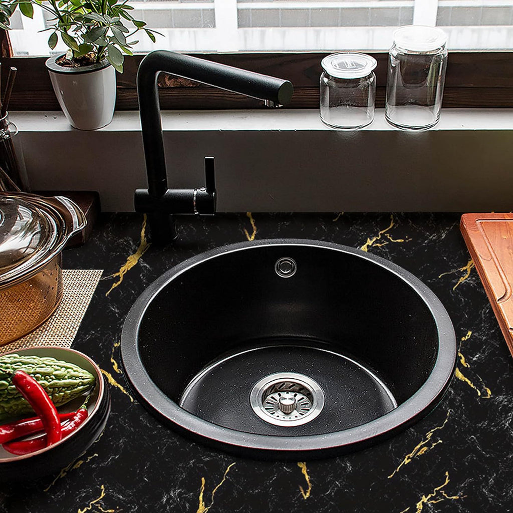 LuxeMarble Vinyl Wrap displayed on black marble countertop with gold veining, featuring round sink and modern black faucet