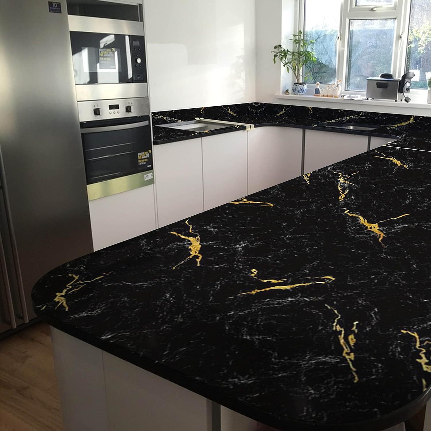 LuxeMarble Vinyl Wrap in black marble with gold veining applied on modern kitchen countertop and cabinet surfaces
