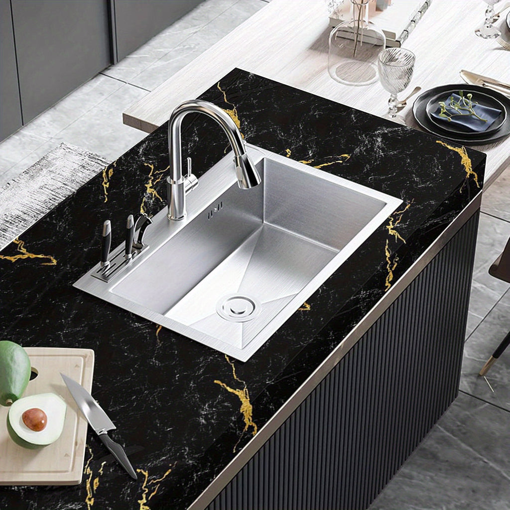LuxeMarble™ black and gold marble vinyl wrap showcased on modern kitchen countertop with stainless steel sink and faucet