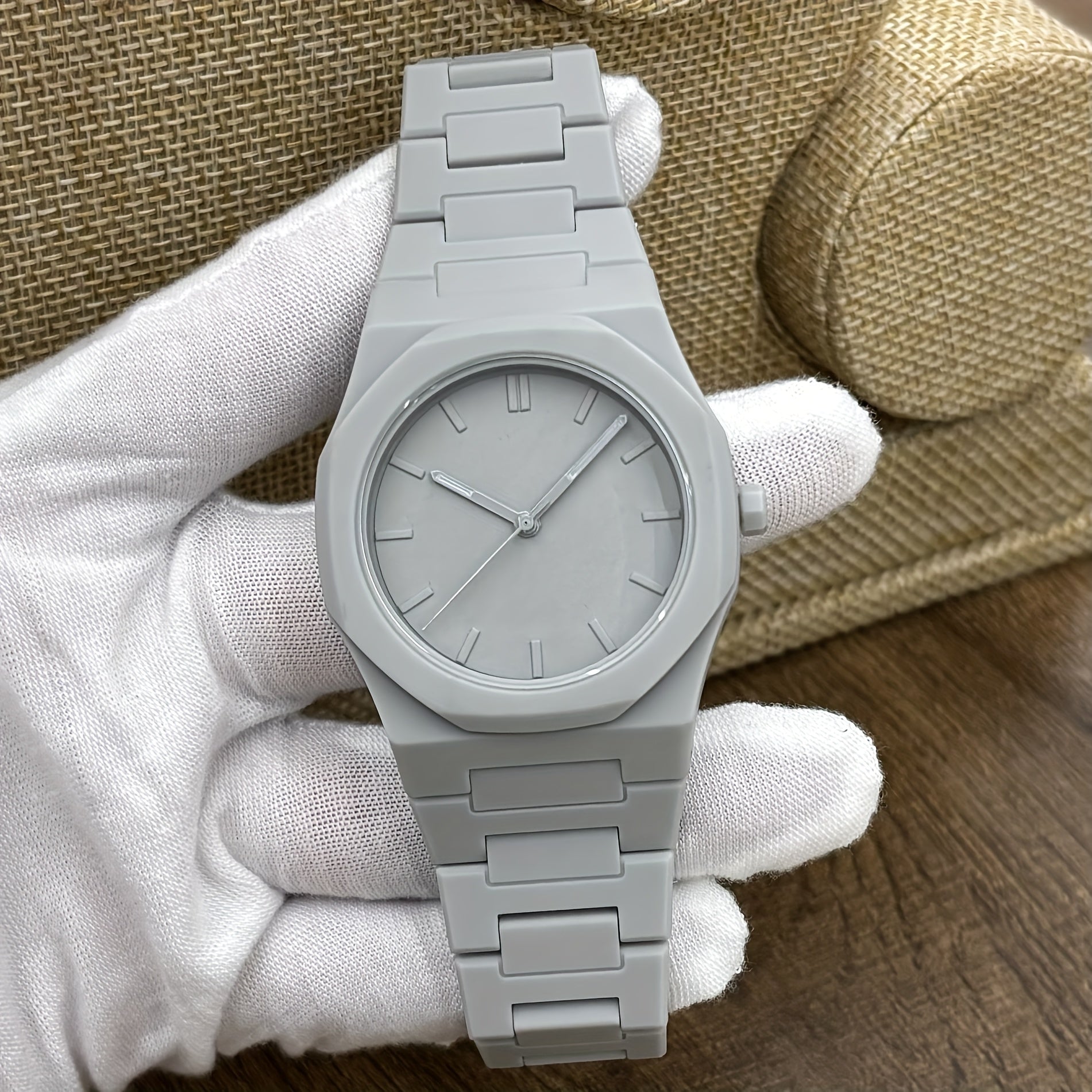 Midnight Phantom stealth watch in sleek matte gray with minimalist dial and metal bracelet on white gloved hand