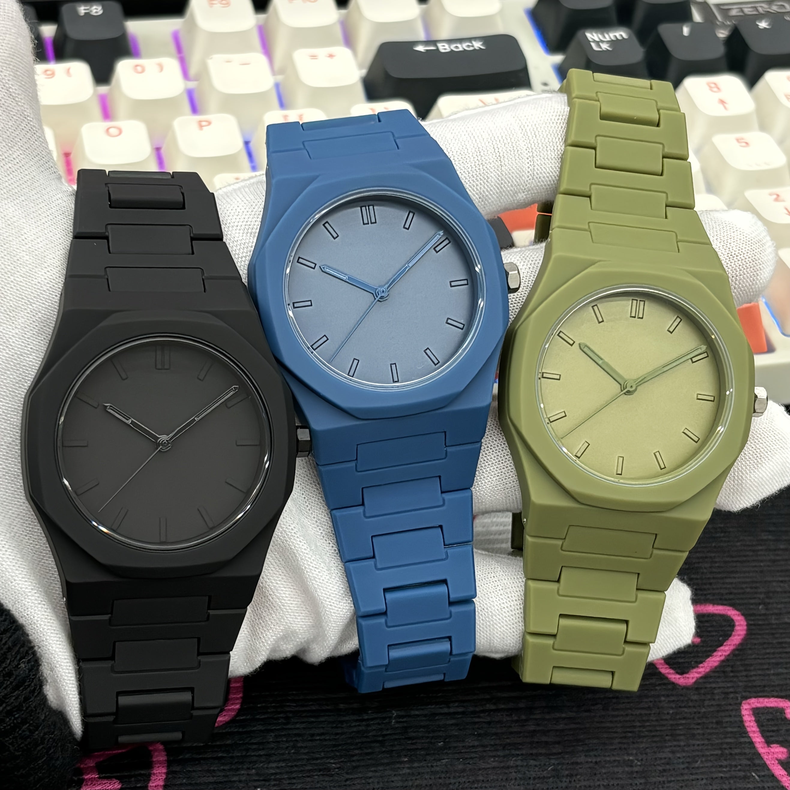 Midnight Phantom stealth watches in matte black, blue, and olive green with minimalist dials and metal link bands