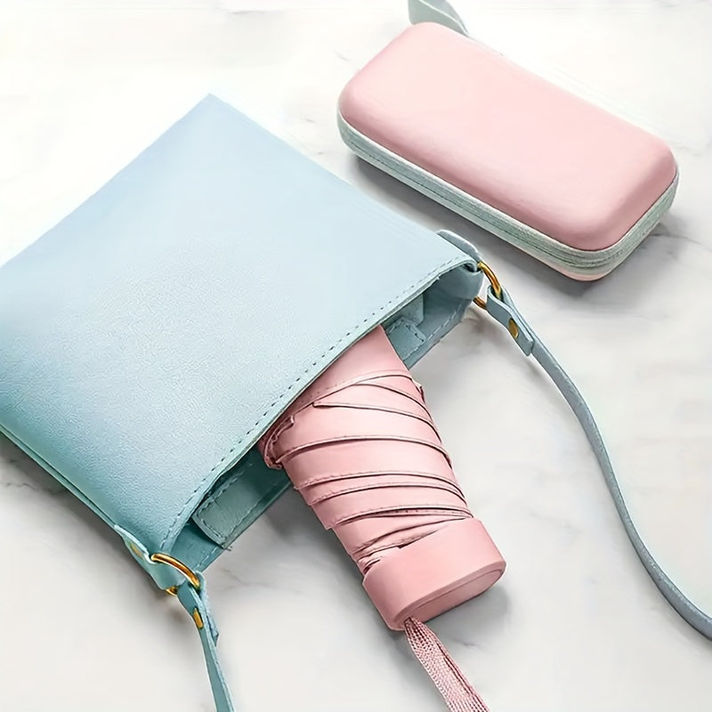 Mini Pocket Umbrella in pastel pink and blue with matching protective case and crossbody purse on marble surface
