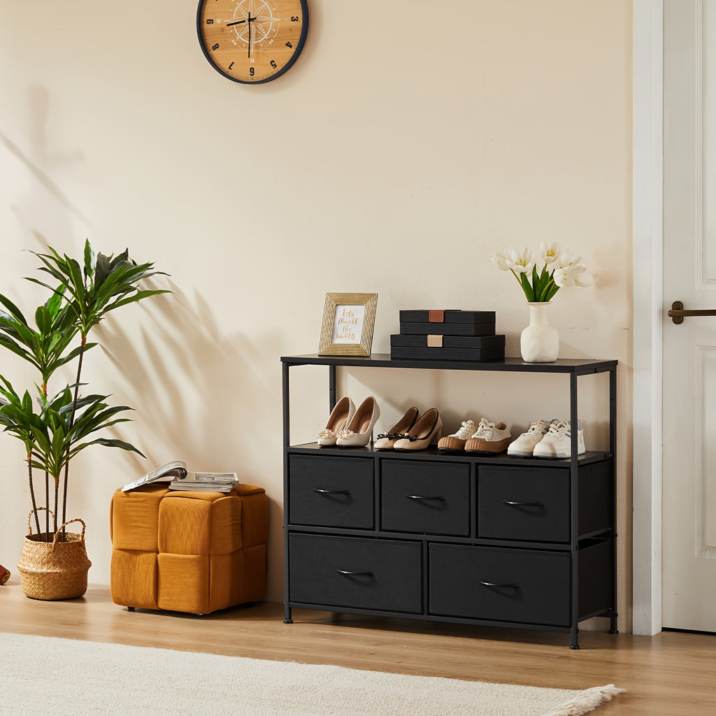 Modern black TV stand and dresser with 5 drawers and shelf, styled with shoes and decor in minimalist room
