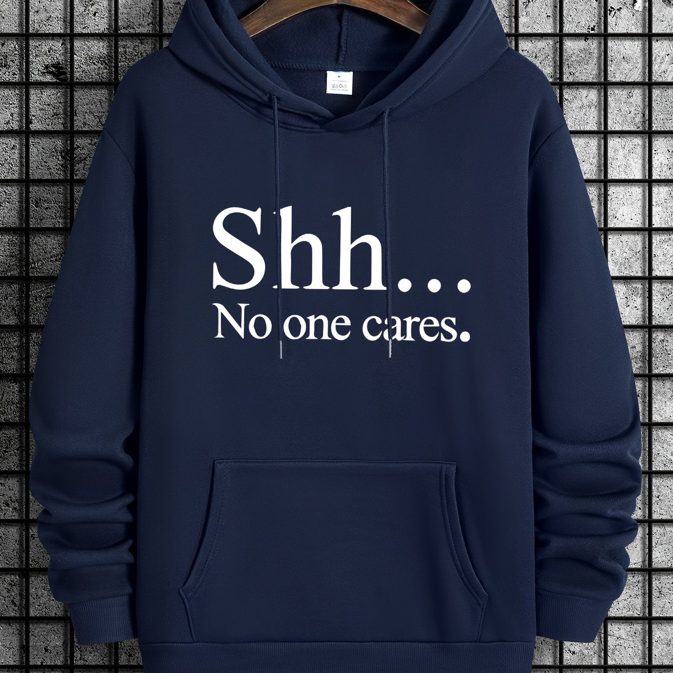 Navy blue Shh No One Cares hoodie with white text print, featuring kangaroo pocket and classic pullover design