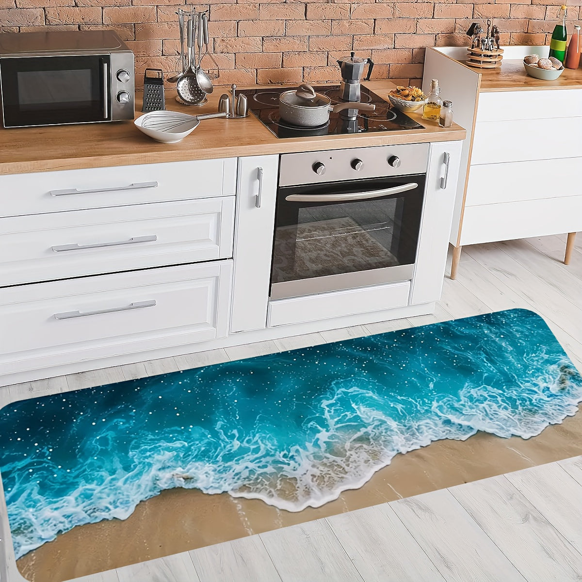 Ocean Bliss anti-fatigue mat featuring turquoise ocean waves and sandy beach design in modern white kitchen with brick wall