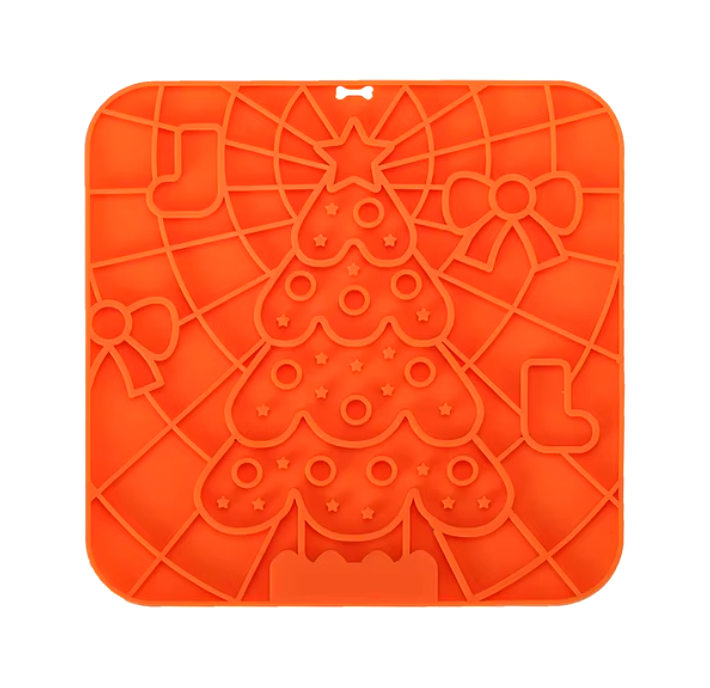 Orange silicone Lick Mat featuring festive Christmas tree pattern with textured grooves for pet treats and enrichment