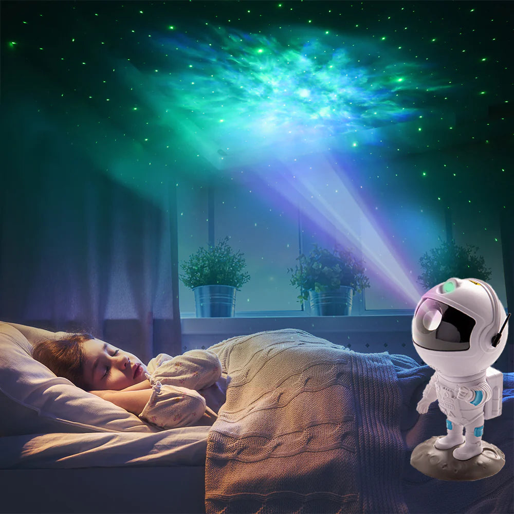 Outer Space Deal astronaut lamp projecting starry nebula display in turquoise and purple onto bedroom ceiling while person rests