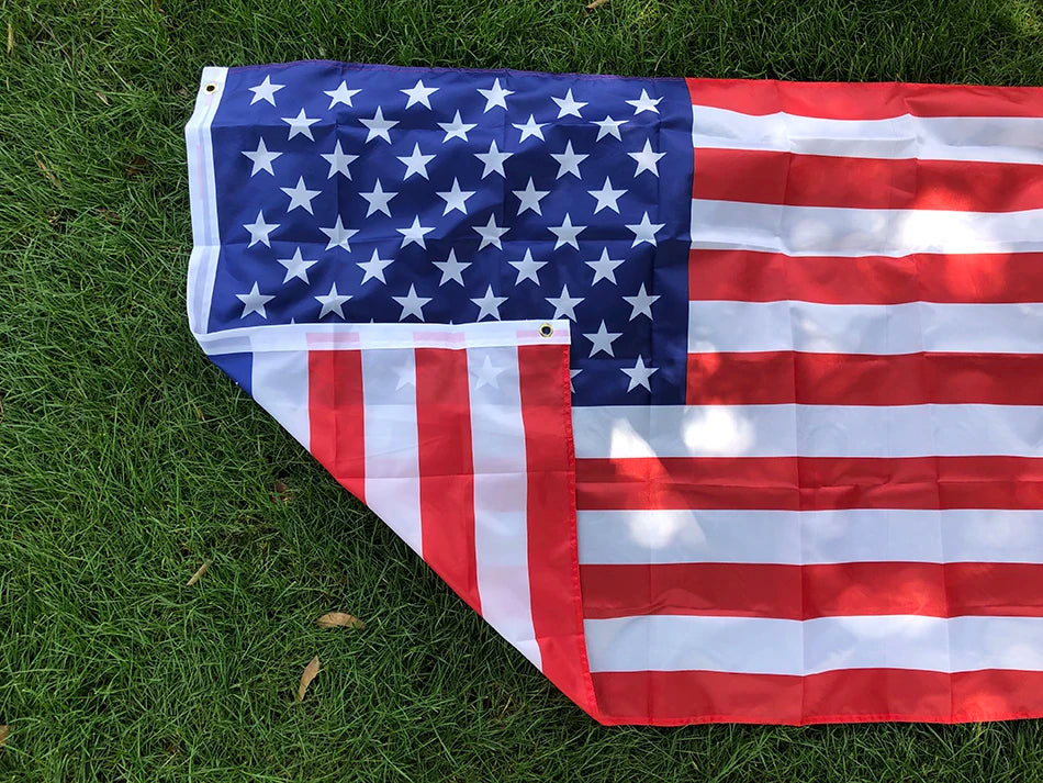 Premium USA Flag double-sided polyester flag displaying vibrant red, white, and blue stars and stripes on green grass background