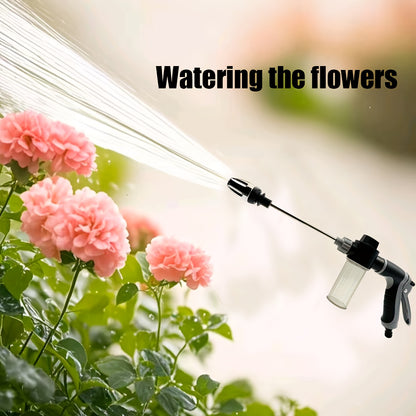 ProClean High-Pressure Car Wash Gun spraying water stream at pink flowers, demonstrating adjustable spray pattern and soap dispenser
