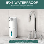 PureTouch automatic soap dispenser in white, waterproof IPX5-rated design shown on marble countertop next to chrome faucet