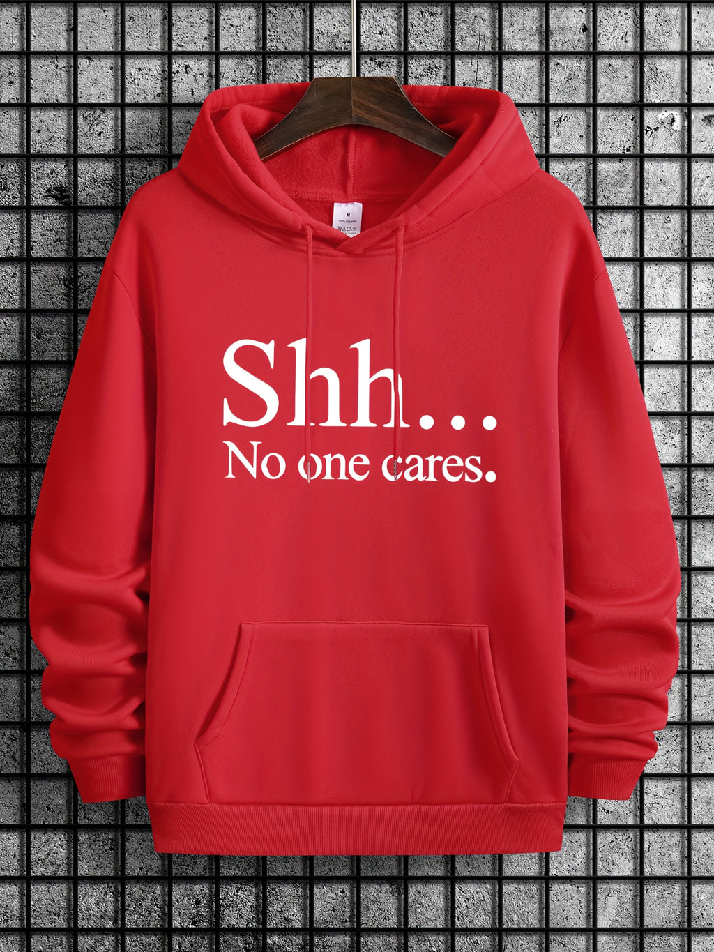 Red pullover hoodie with "Shh... No One Cares" text in white print, featuring kangaroo pocket and classic drawstring design