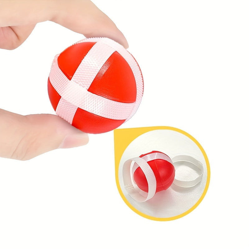 Red sticky ball for DinoBlaster target game with white grip bands shown next to clear storage case on white background
