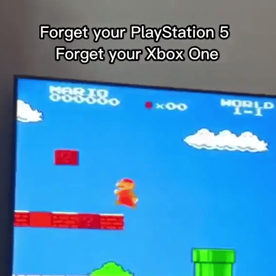 Retro Game Stick GIF showing classic Mario gameplay with pixelated graphics, blue sky, and green pipes on TV display