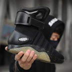 HighPeak NeoVolt Sneakers in black with LED accents, padded ankle strap, and translucent sole held by person outdoors