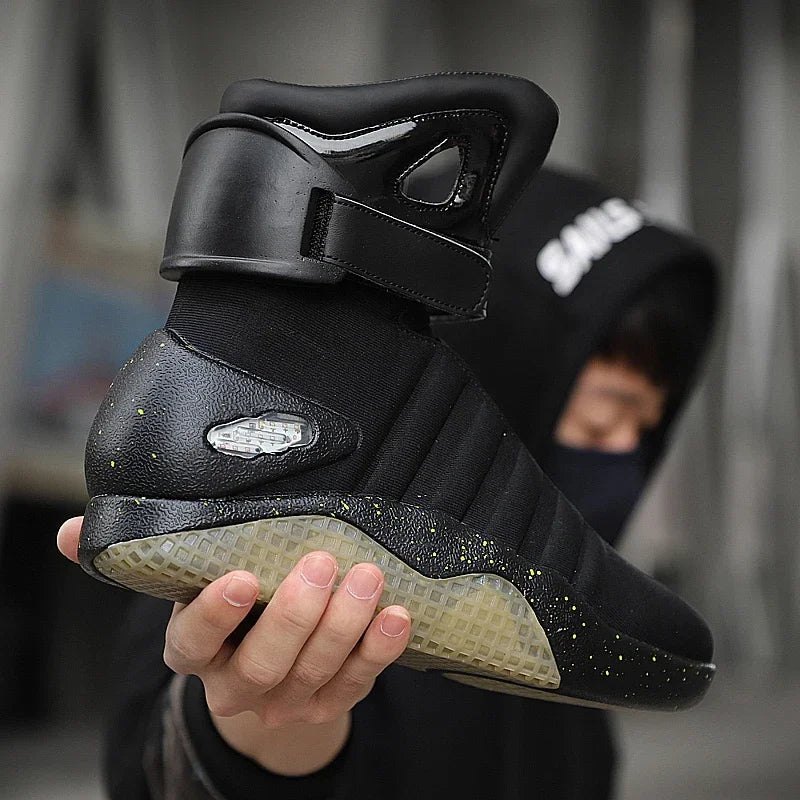 HighPeak NeoVolt Sneakers in black with LED accents, padded ankle strap, and translucent sole held by person outdoors