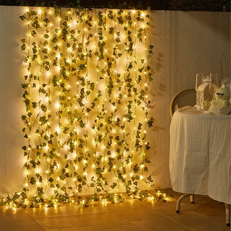 HighPeak GlowVine Lights glowing warm LED ivy vines hanging on white wall next to cozy table setting