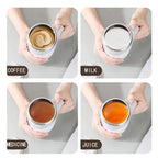 HighPeak Self Stirring Mug in white mixing coffee, milk, medicine, and juice held in hand on a light surface