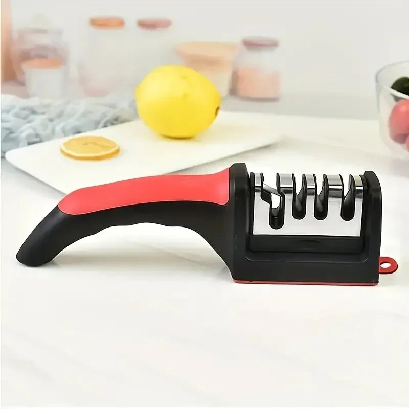 HighPeak Knife Sharpener with black and red ergonomic handle on white countertop with lemon in background