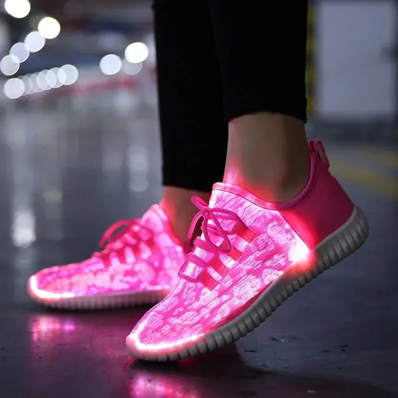 HighPeak Glowstride Sneakers in bright pink with fiber optic glow and LED lighting worn indoors on a reflective floor