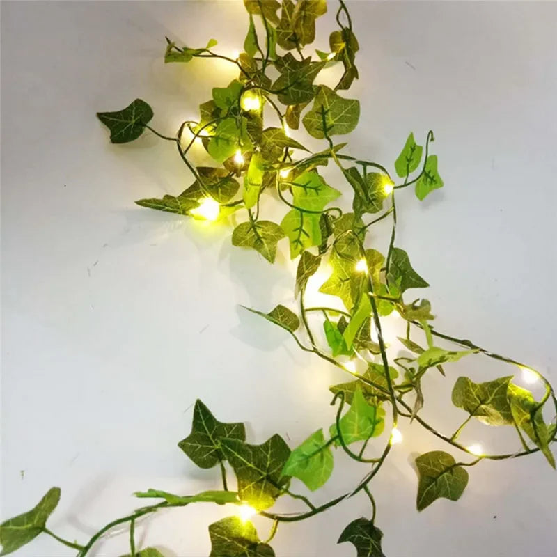 HighPeak GlowVine Lights glowing warm LED ivy vines draped on a white wall creating cozy ambient lighting