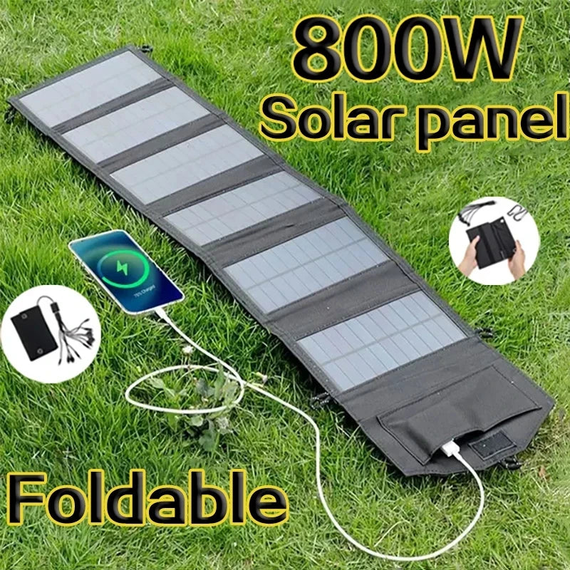 SunVolt Solar Panel foldable black 800W charger on grass powering a phone with USB and DC ports by HighPeak