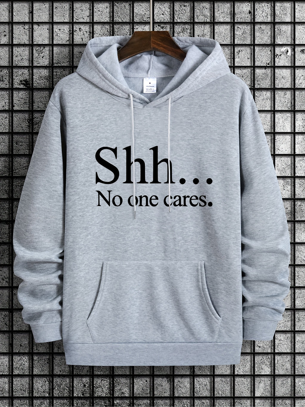 SHH No One Cares hoodie in light gray with black text print, front kangaroo pocket, casual streetwear design