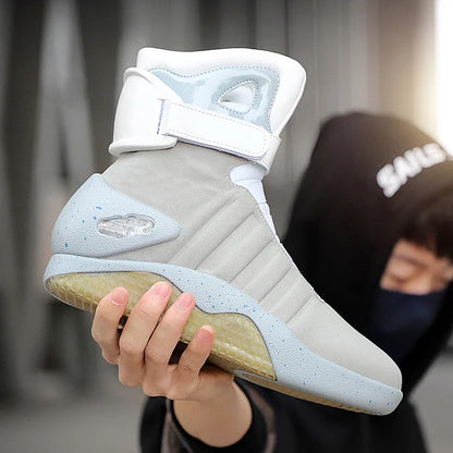 NeoVolt Sneakers in light gray with white strap and speckled sole held by person, showcasing futuristic design and comfort.