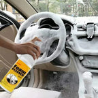 HighPeak FoamBlitz Cleaner foaming thick on a car steering wheel and dashboard for deep multi-surface cleaning