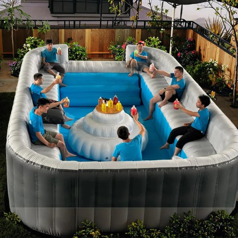 HighPeak Inflatable Sofa Pool in gray and blue with built-in lounge seating holding drinks outdoors