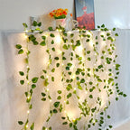 HighPeak GlowVine Lights draped with warm LED fairy-lit ivy vines on a white curtain for cozy decor ambiance
